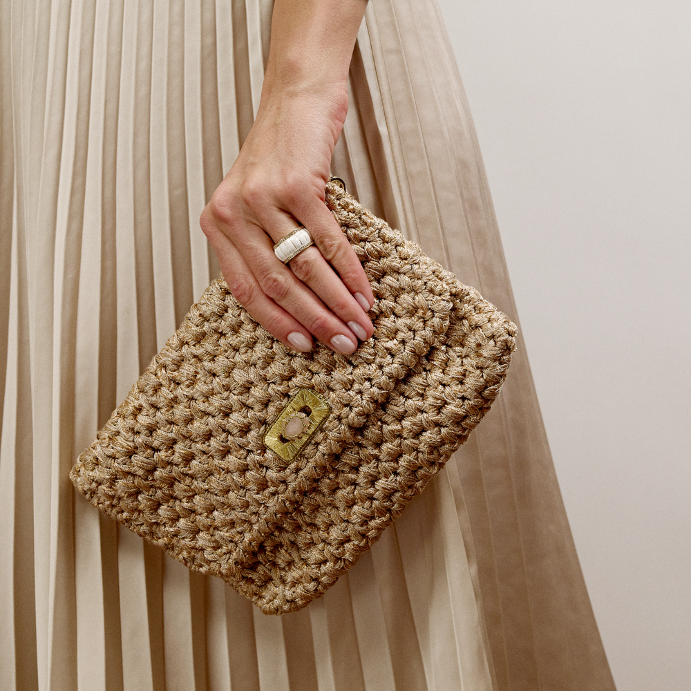 Merrichase woven clutch in beige on model