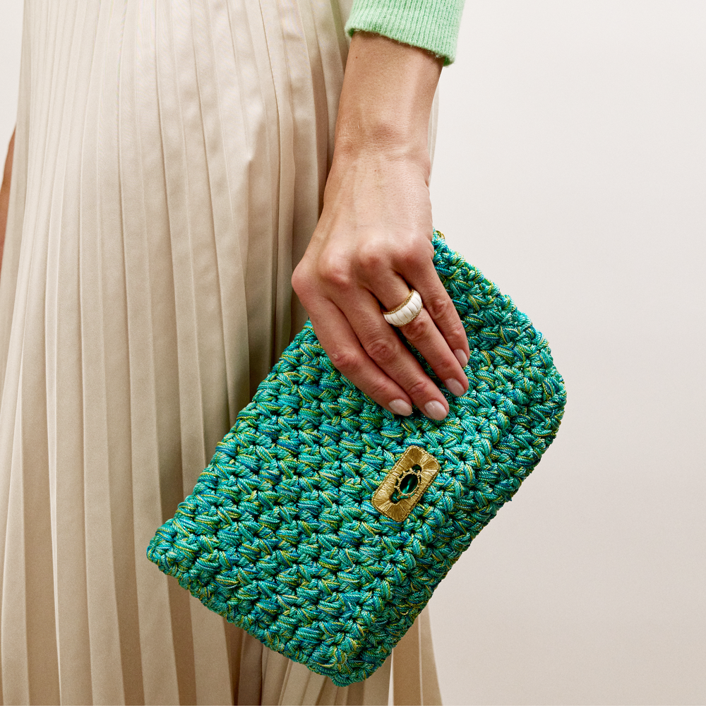 Merrichase woven clutch in turquoise on model